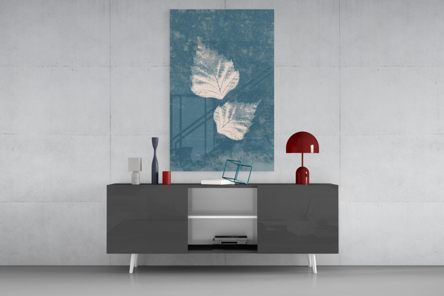 Teal glass wall art with white leaf designs displayed above a dark media console with red and white decorative accessories.