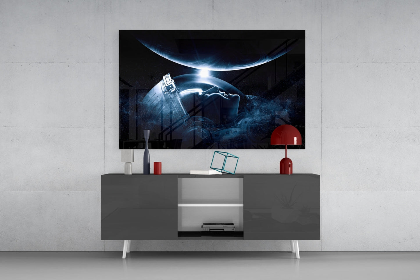Astronaut's Look Glass Wall Art displayed on gray media console with red lamp and white decor accessories against white brick wall.