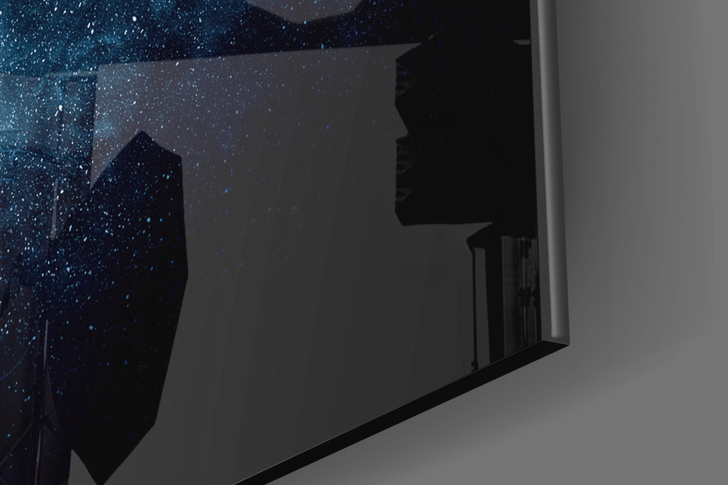 Wall-mounted black framed glass panel displaying starry night sky with silhouetted buildings, angled perspective view.