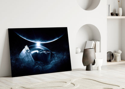 Canvas artwork leaning against white wall showing blue-lit spacecraft and planets in dark space, displayed in minimalist room setting.