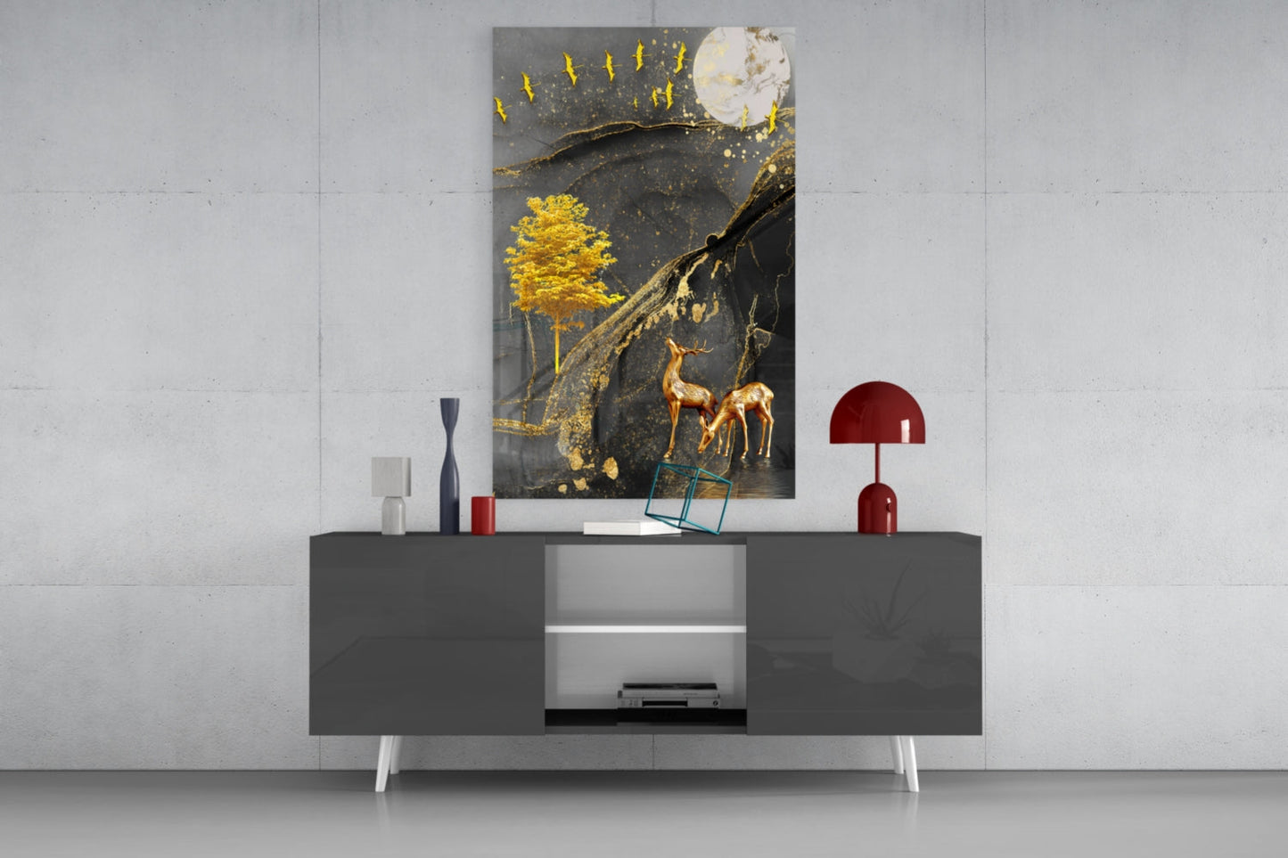 Modern living room styled display of golden tree and gazelle glass wall art mounted above gray media console with red accents.
