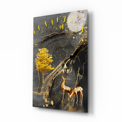Angled side view of glass wall art featuring gold deer and tree against dark background with moon and flying birds.