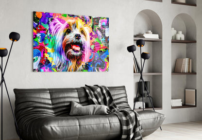 Colorful pop art glass wall art of a smiling dog with rainbow brushstrokes displayed above a black leather sofa in a modern living room.