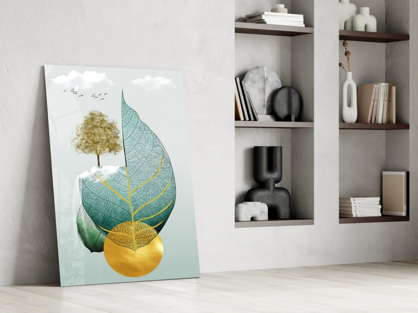 Glass wall art leaning against white wall displays gold tree and layered teal, green, and yellow leaves with birds.