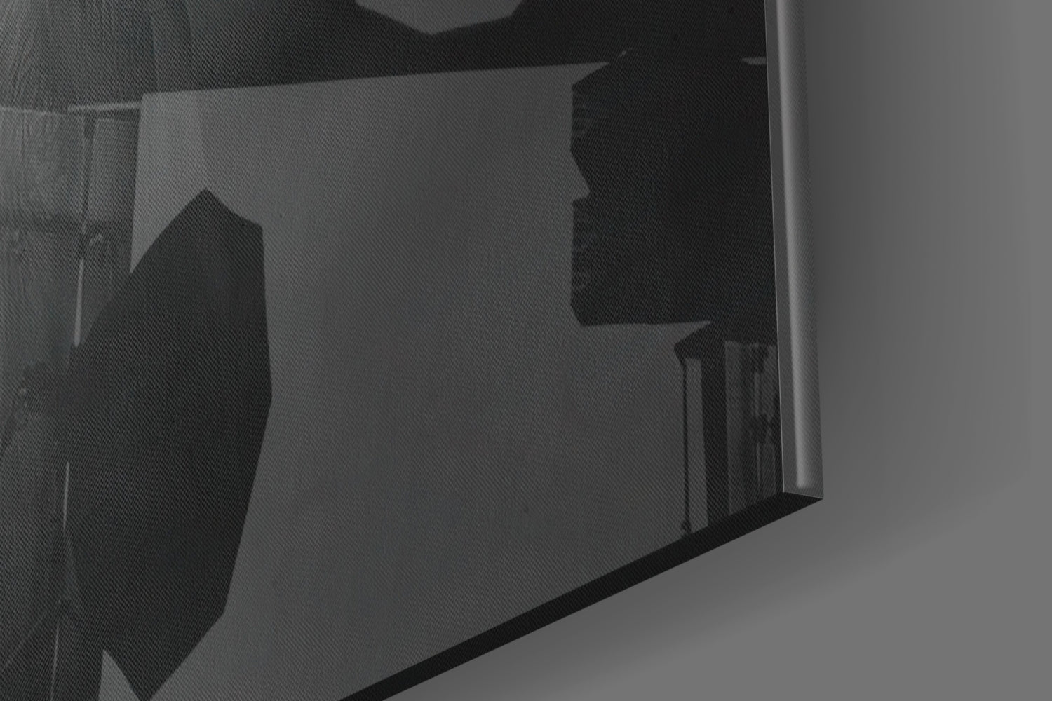 Close-up angled view of translucent glass panel displaying silhouetted hat design in black against grey background.