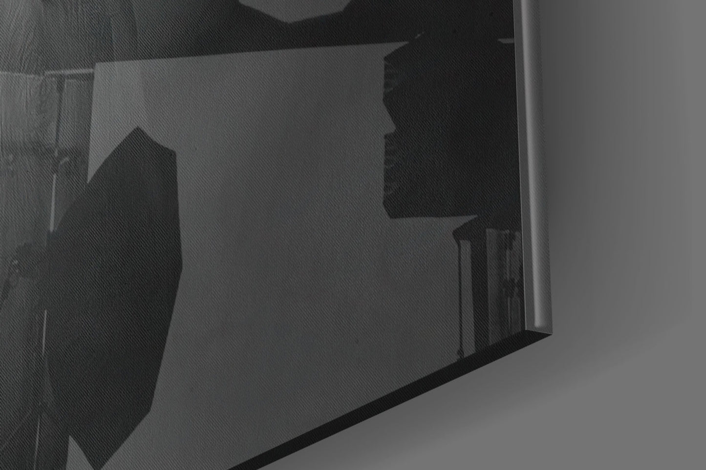 Close-up angled view of translucent glass wall art panel showing silhouetted yellow hat design against frosted glass surface.