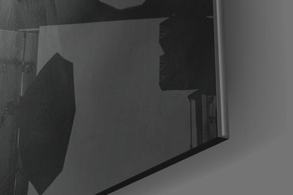 Close-up angled view of translucent glass wall art panel showing silhouetted yellow hat design against frosted glass surface.
