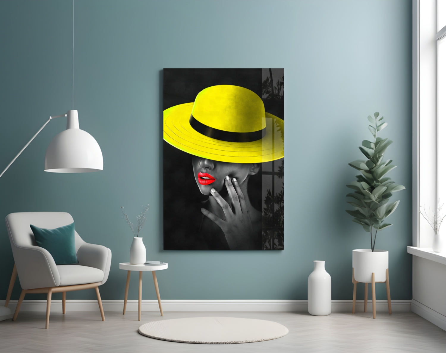 Yellow Hat Glass Wall Art displayed on teal wall above white chair in modern living room setting.