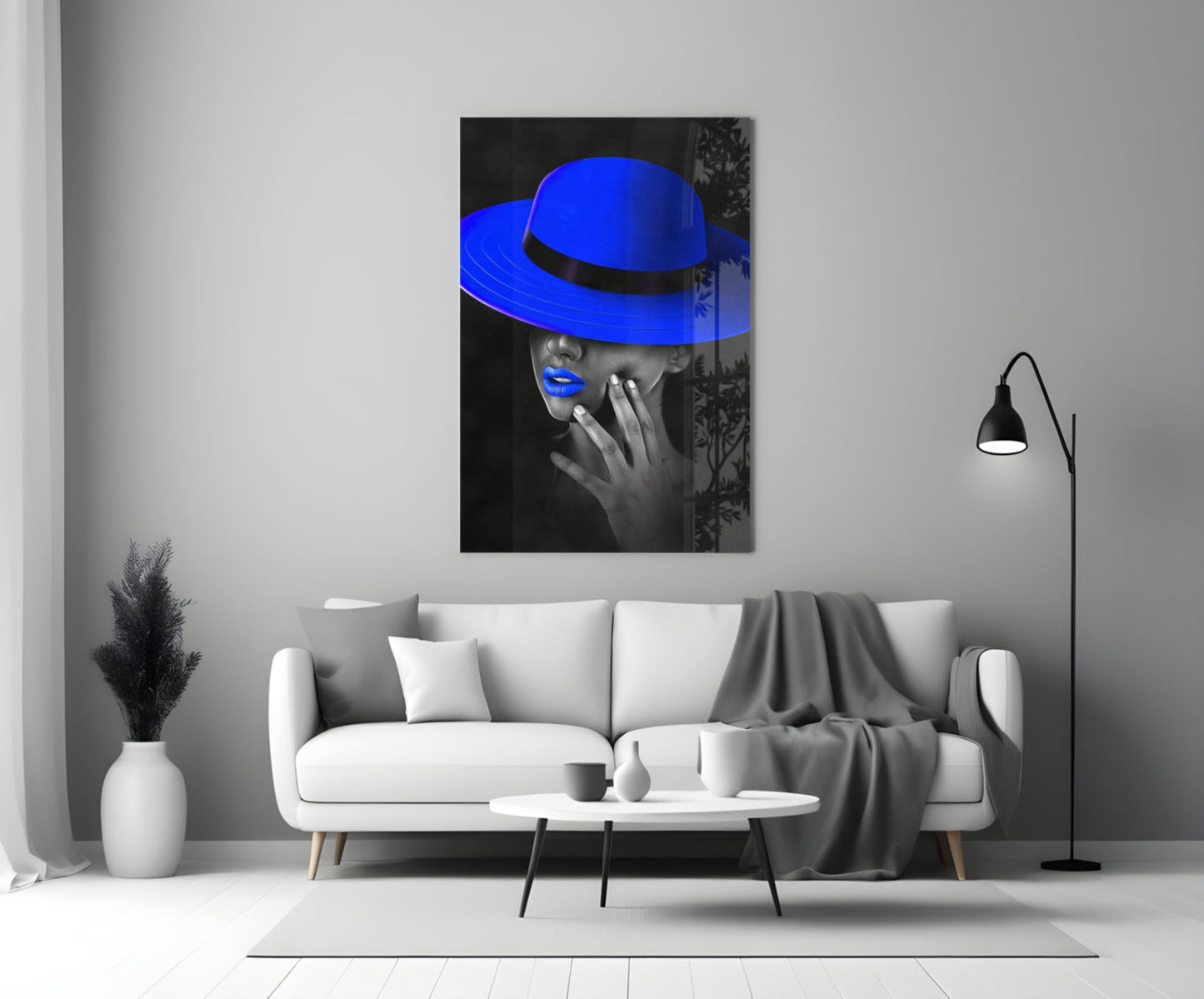Blue Hat Glass Wall Art displayed above white sofa in modern living room with pampas grass and black floor lamp.