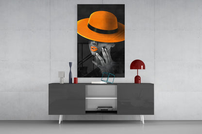 Orange Hat Glass Wall Art displayed on a gray media console with decorative accessories in a modern interior setting.