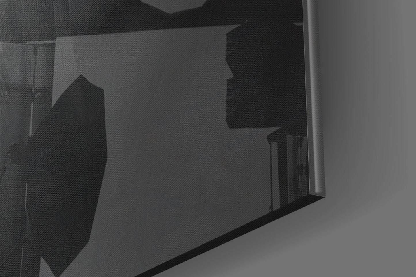 Close-up angled view of glass wall art showing silhouetted orange hat design through translucent glass panel.