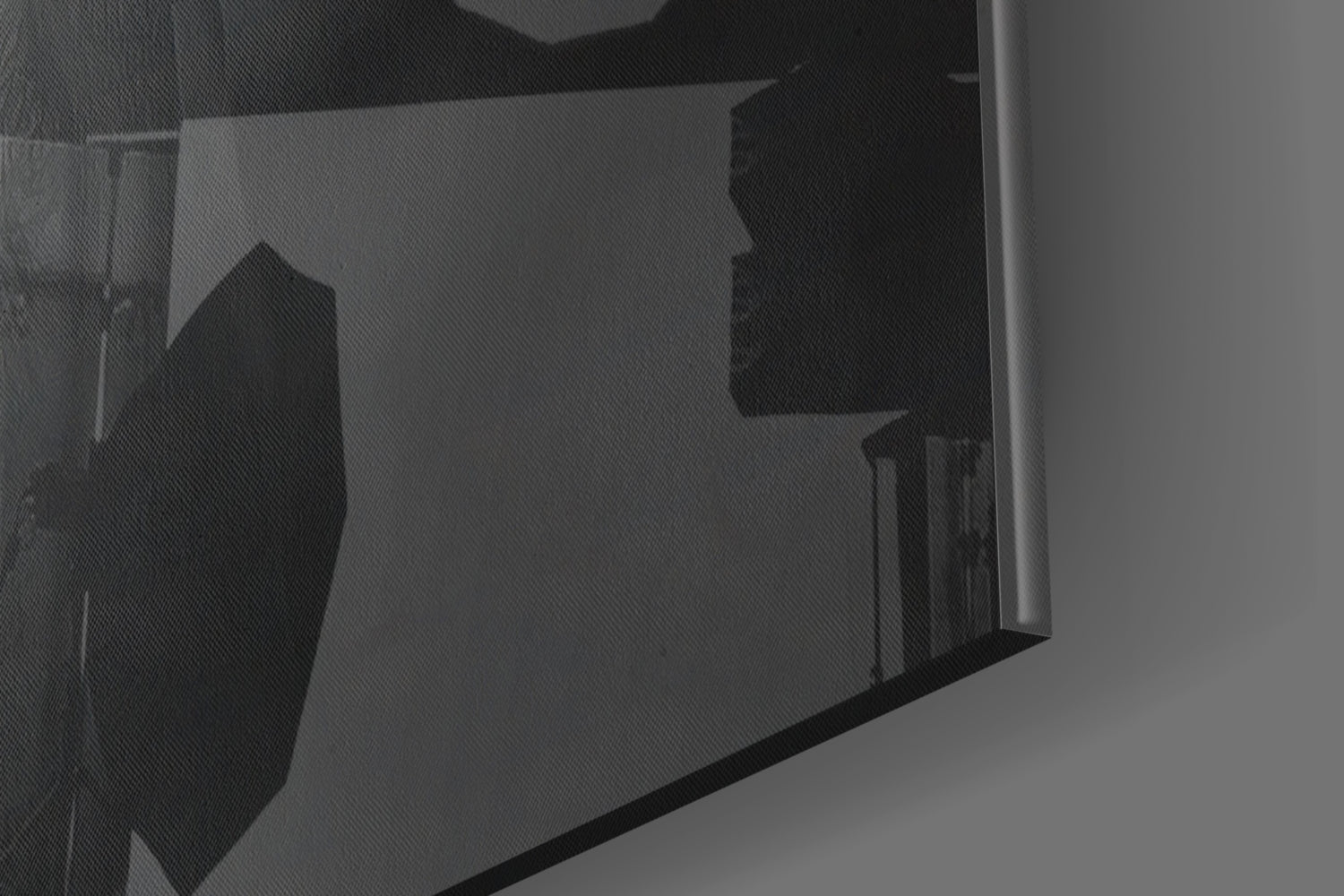 Close-up angled view of glass wall art showing silhouetted orange hat design through translucent glass panel.