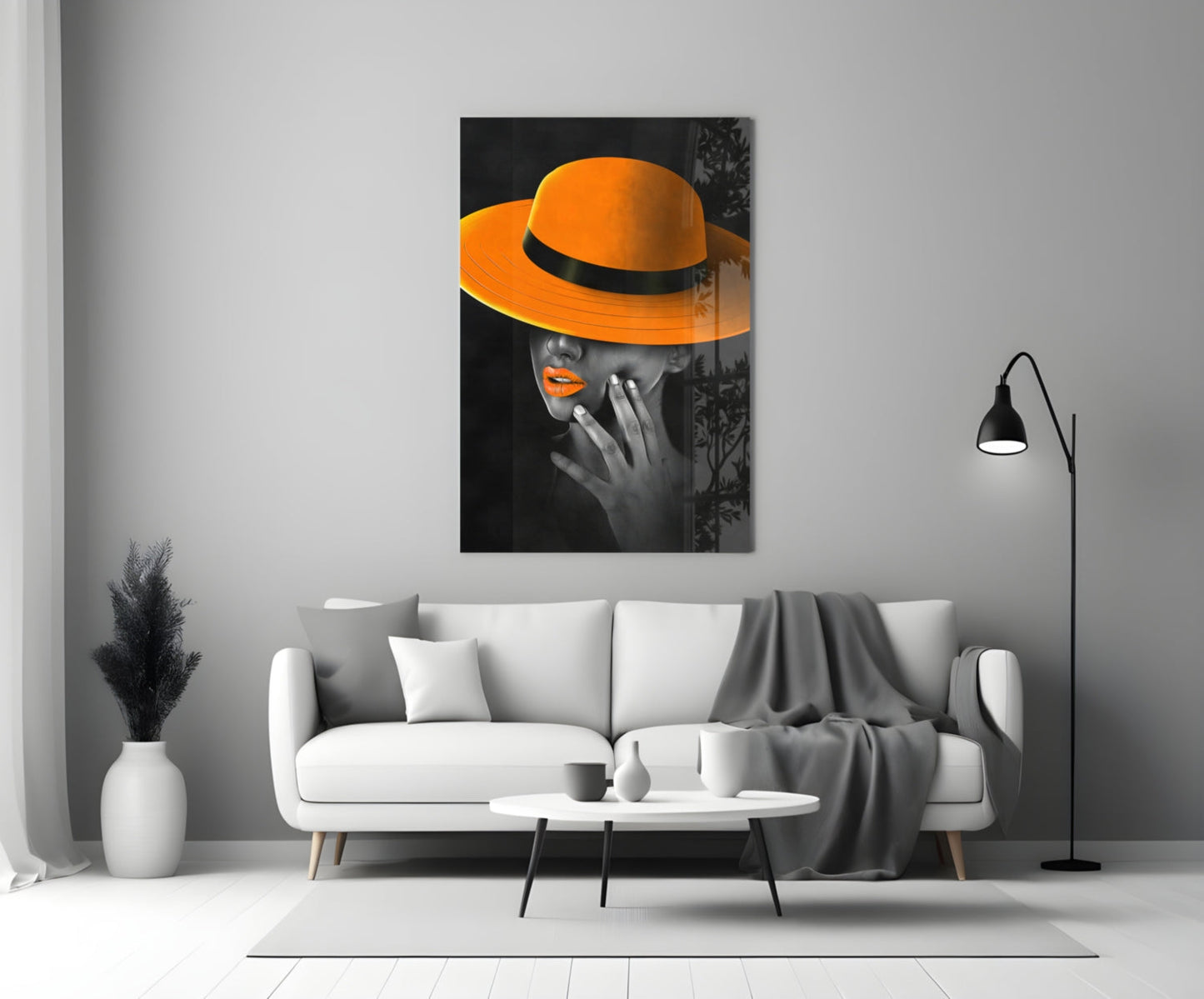 Orange Hat Glass Wall Art displayed above white sofa in modern living room setting with black floor lamp.