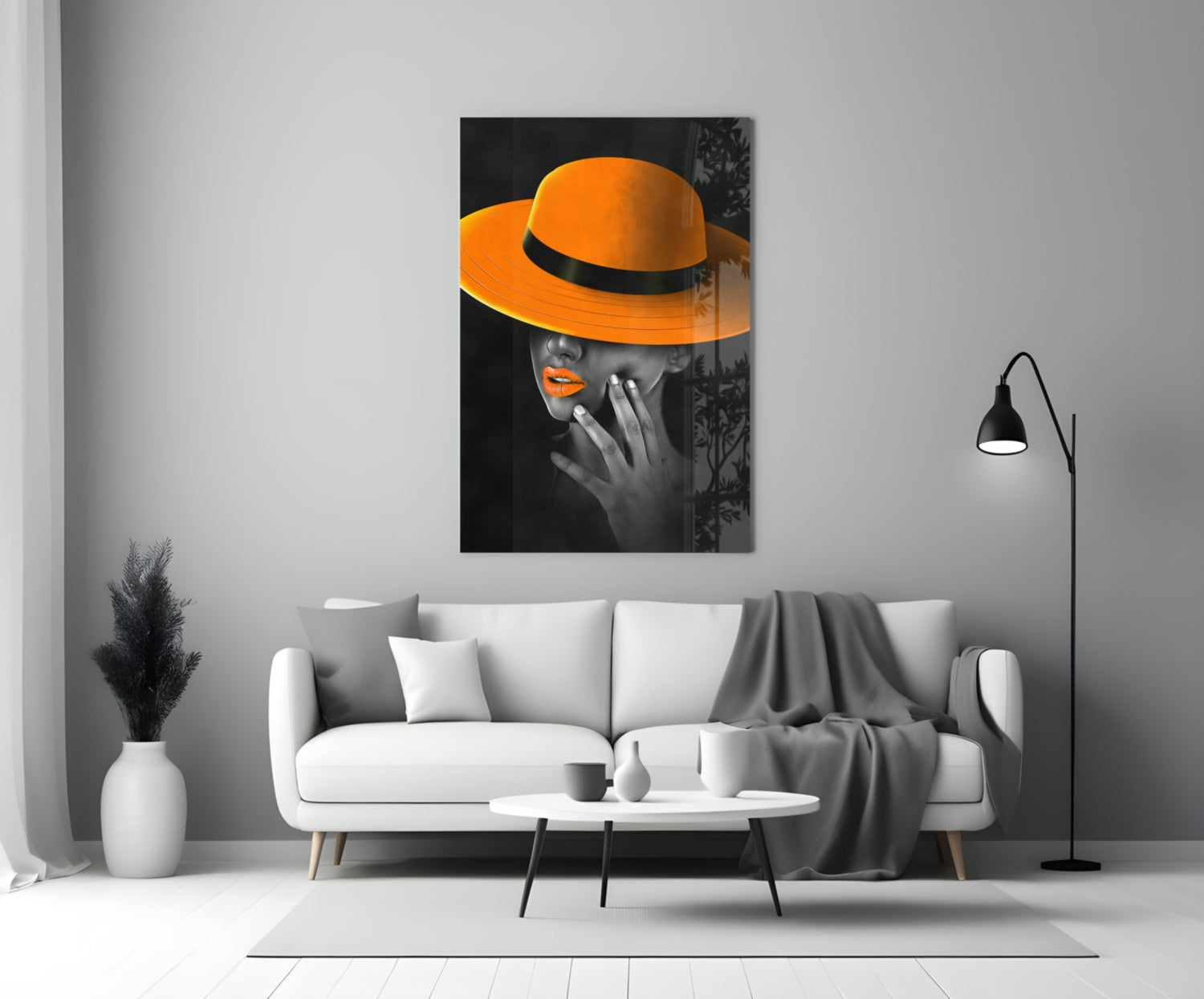 Orange Hat Glass Wall Art displayed above white sofa in modern living room setting with black floor lamp.
