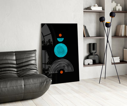 Modern living room interior featuring geometric glass wall art with turquoise circle, white semicircle lines, and orange accents on black background.