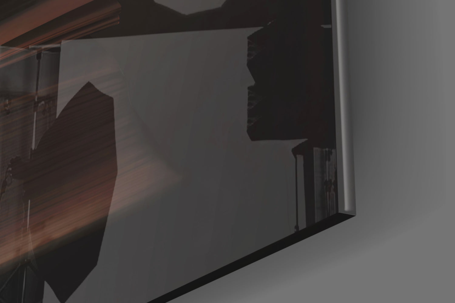 Close-up angled view of frosted glass wall art displaying dark silhouette of tree against translucent white surface with black frame edge visible.