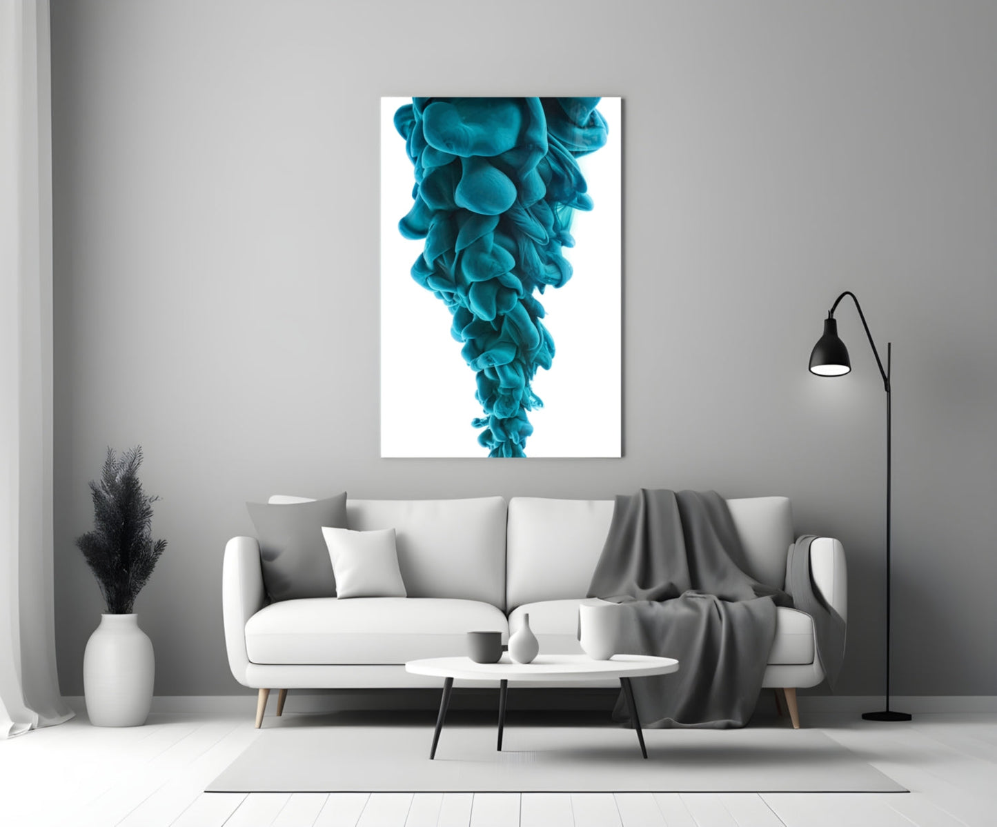 Turquoise layered glass art print displayed above a white sofa in a minimalist living room interior.