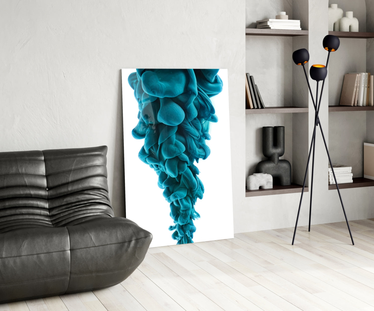 Modern living room interior showcasing blue layered glass wall art displayed on white wall beside black leather sofa.