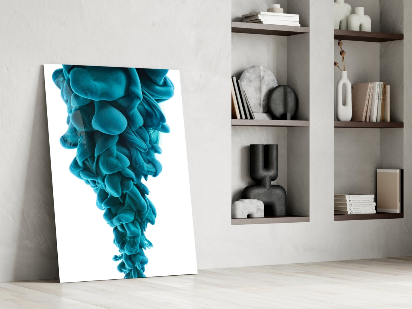 Blue Layers Glass Wall Art leaning against white wall beside shelving unit displaying books and decorative objects.