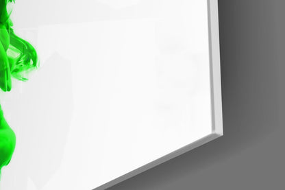 Green layered glass wall art leaning against gray wall, showing white interior pages and green sculptural edge detail.