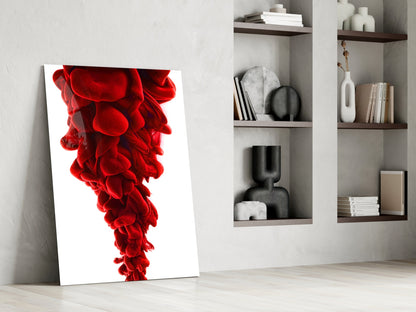 Red Layers Glass Wall Art leaning against white wall beside shelving unit displaying decorative objects and books.