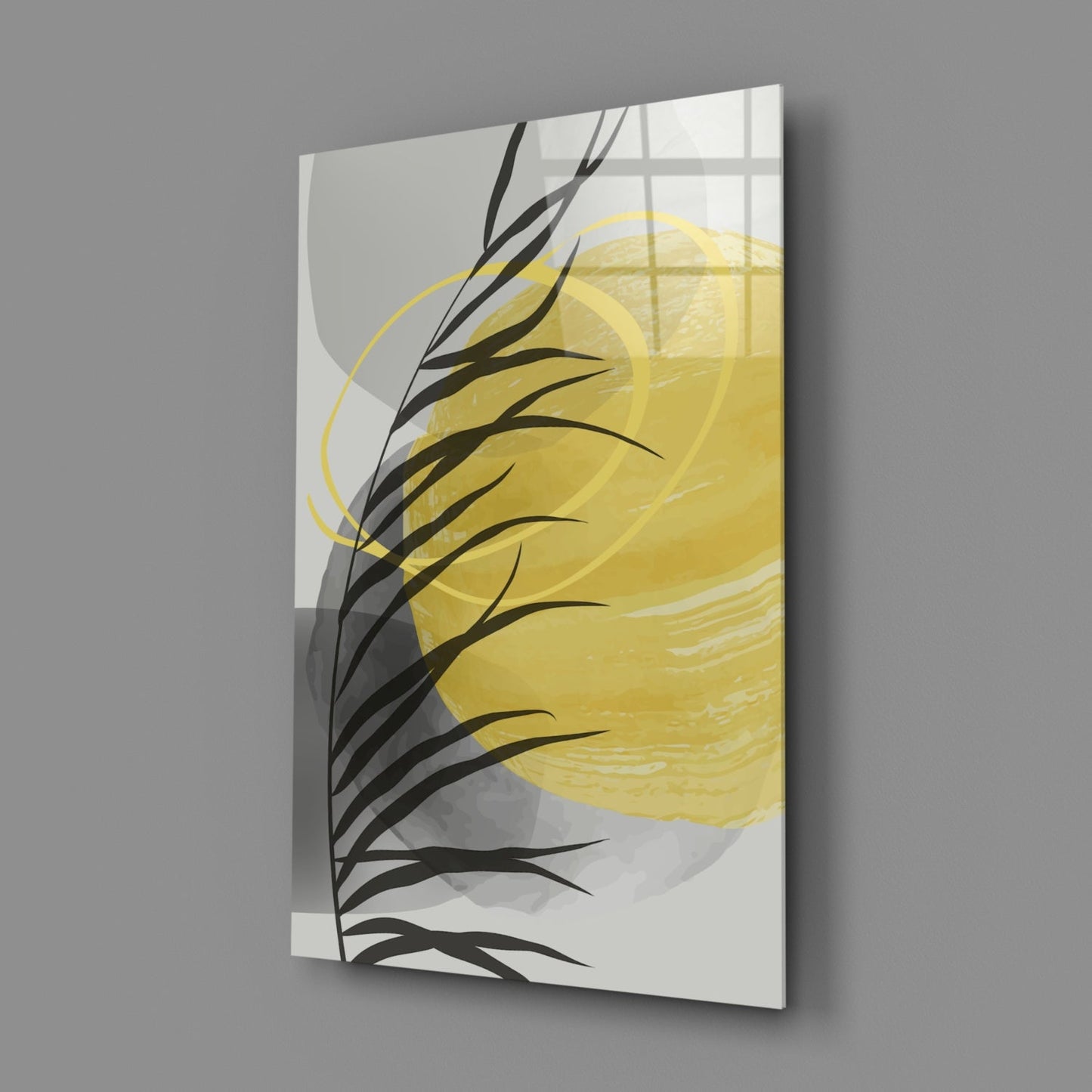 Angled perspective view of glass wall art with black branch silhouette, yellow brushstroke, and geometric window pane pattern on cream background.