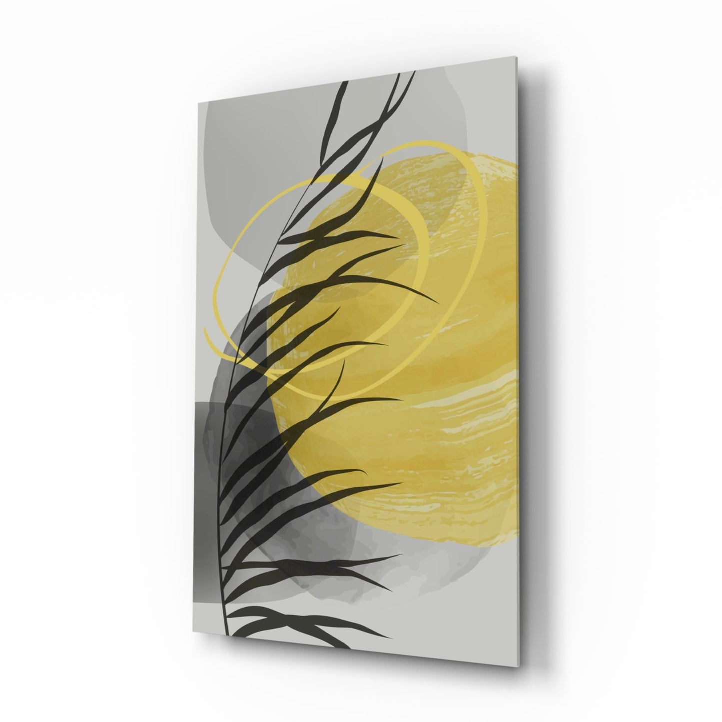 Angled view of glass wall art featuring yellow brushstroke and black branch design on gray background.