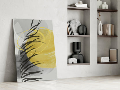Modern interior styled with leaning yellow and black botanical canvas art beside white wall shelving displaying books and decorative objects.