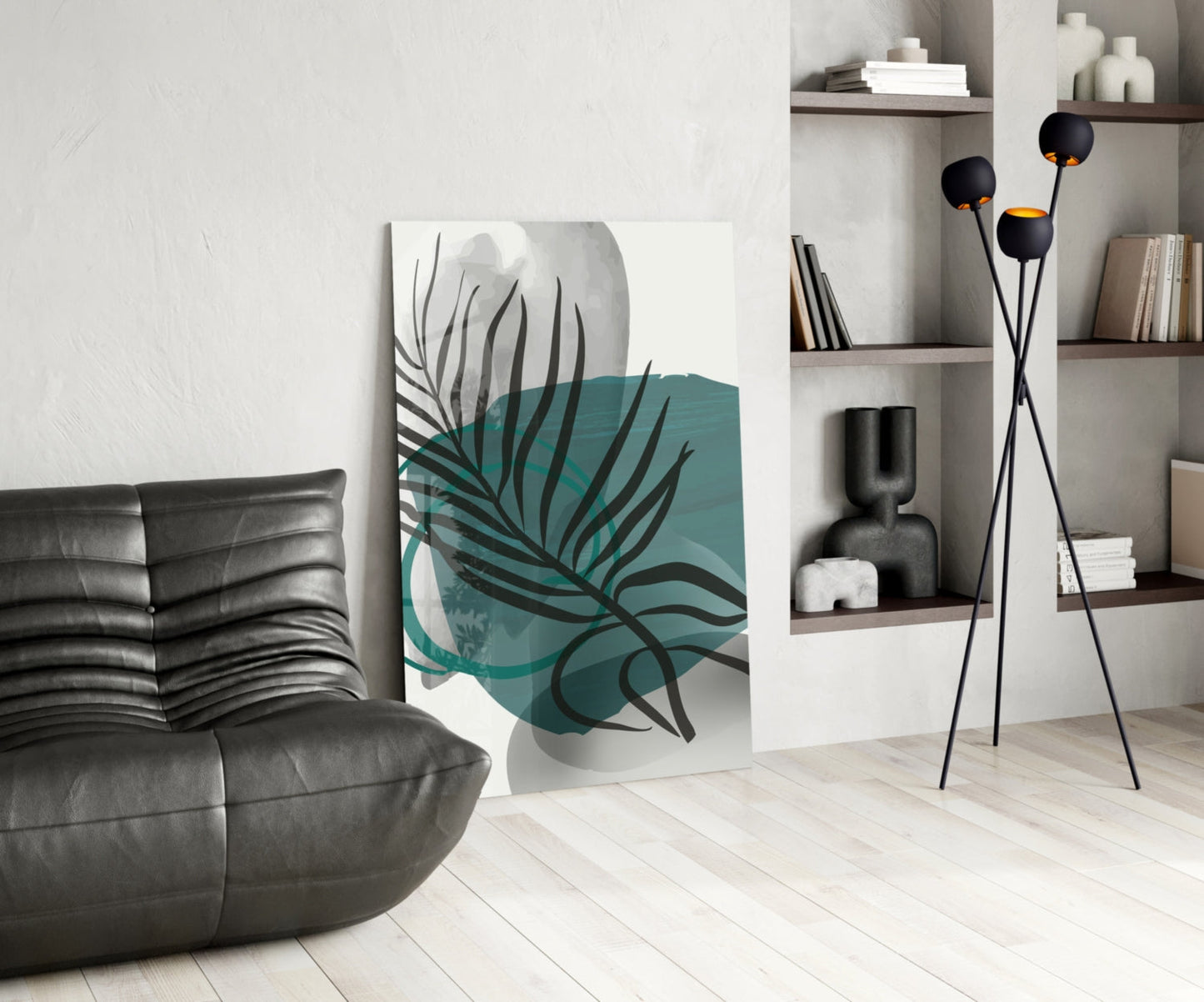 Modern living room with Autumn Green Glass Wall Art displaying teal and black botanical leaf design leaning against white wall.