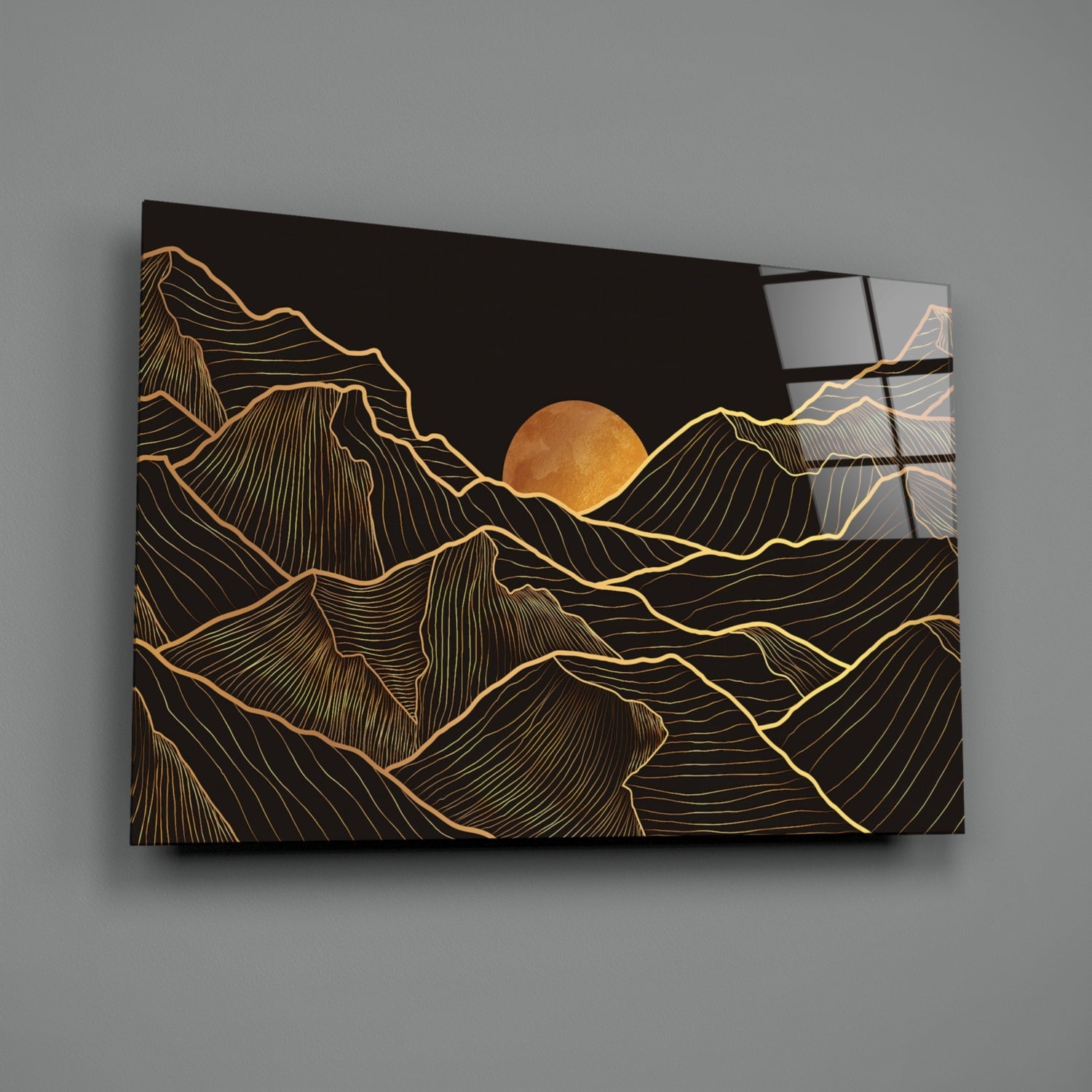 Black glass wall art with gold line-drawn mountains and full moon, displayed at an angle showing depth and reflective surface.
