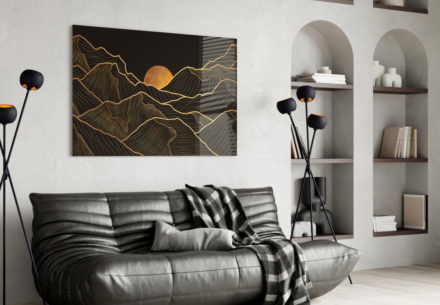 Black and gold mountain landscape with sun glass wall art displayed above gray leather sofa in modern living room.