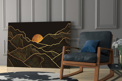 Black glass wall art with gold line-drawn mountains and orange sun, displayed in modern living room beside wooden chair.
