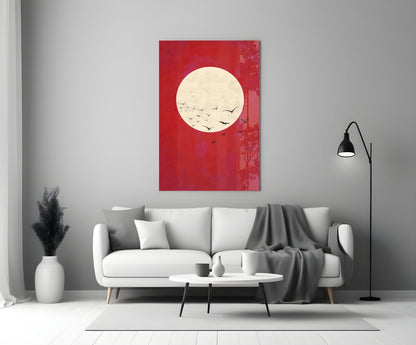 Red glass wall art with cream moon and flying birds displayed above white sofa in modern living room.