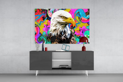 Colorful pop art eagle glass wall art mounted above a dark and white TV console in a modern living room setting.