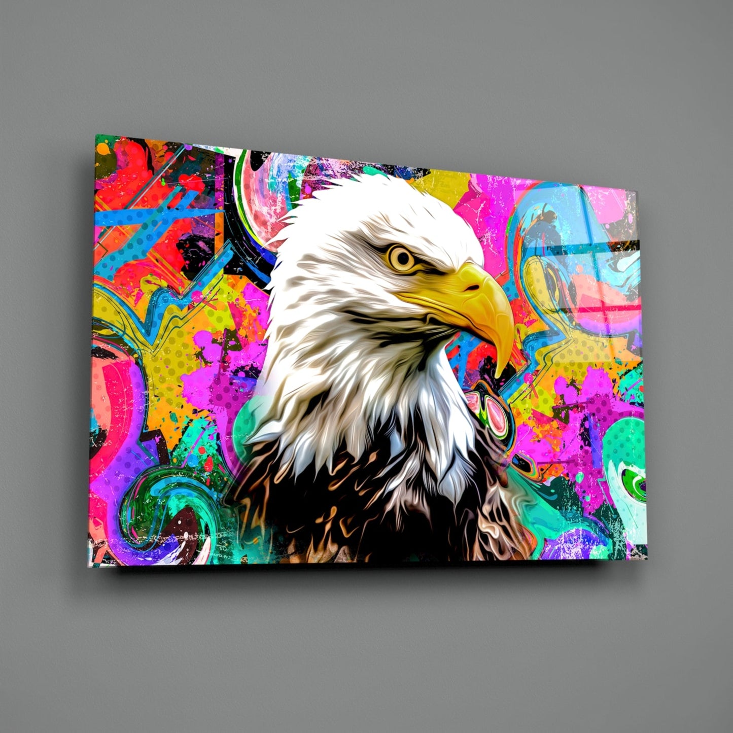 Vibrant glass wall art featuring a bald eagle's head against a colorful abstract background with neon pink, yellow, blue, and green patterns.