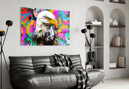 Colorful pop art eagle head glass wall art displayed above black leather sofa in modern living room with built-in shelving.