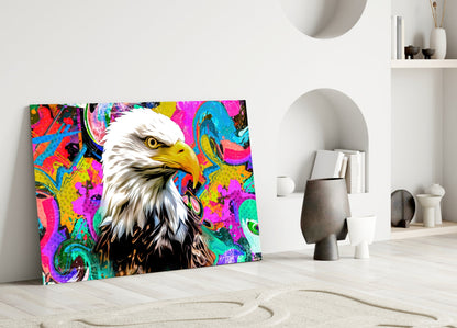 Colorful pop art eagle glass wall art leaning against white wall in minimalist interior setting.