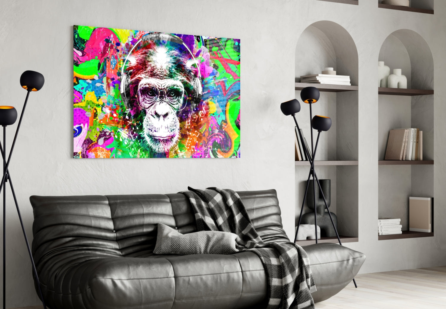 Vibrant pop art monkey face glass wall art hanging above black leather sofa in modern living room interior.