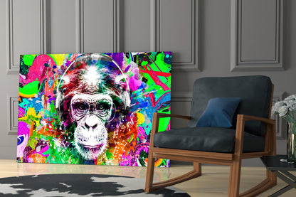 Vibrant pop art monkey wearing headphones on glass wall art displayed in modern living room next to wooden rocking chair.