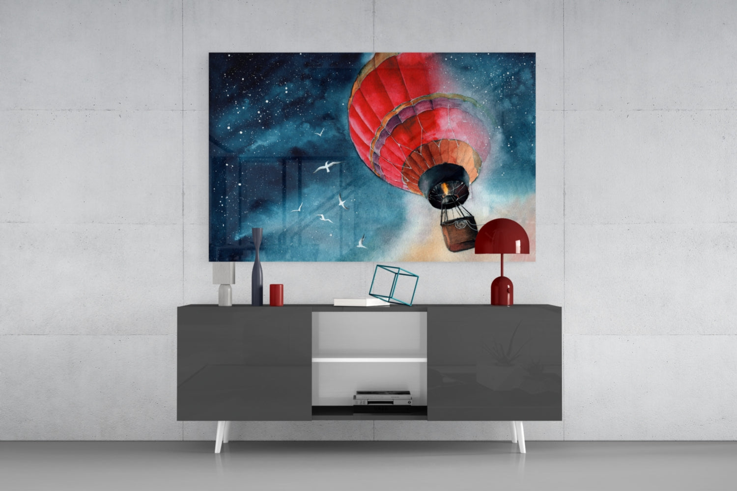 Red hot air balloon ascending through starry night sky displayed above gray media console in modern interior setting.