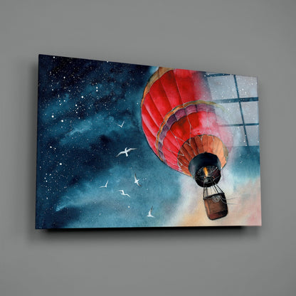 Red hot air balloon with wicker basket floating against starry night sky and daytime clouds on glass wall art panel.