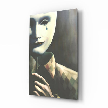 Three-dimensional angled view of a glass wall art panel displaying a pale mask with a tear, worn by a figure in a patterned jacket against a dark background.