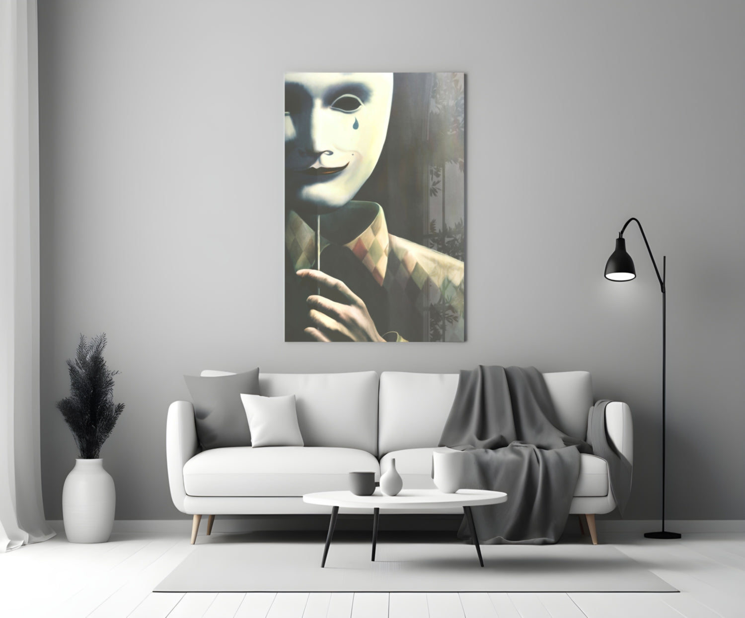 Glass wall art depicting a figure in white mask with tear, wearing brown jacket, displayed above white sofa in modern living room.