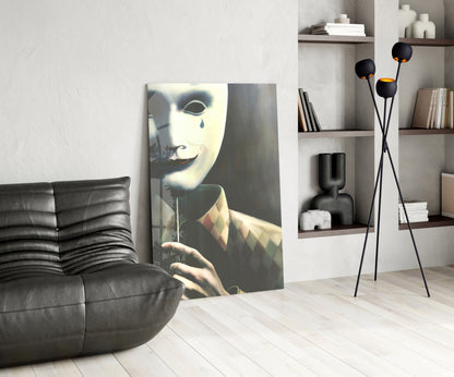 Glass wall art depicting a pale masked face with blue tear and geometric patterned clothing displayed in modern living room interior.