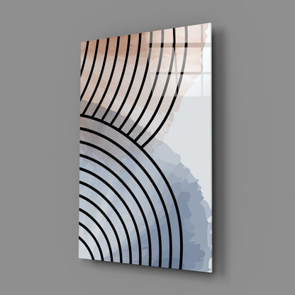 Angled view of glass wall art displaying black curved lines against cream and blue gradient background, mounted on gray wall.