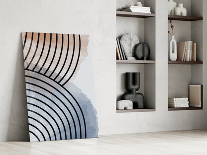 Modern glass art leaning against white wall displaying curved black lines on peach and blue gradient background, styled with wall shelves.