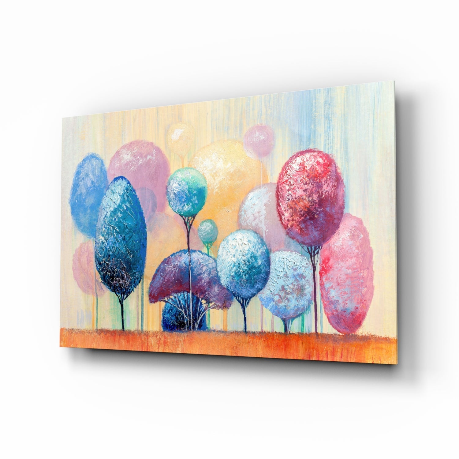 Angled view of glass wall art depicting colorful stylized trees in blue, pink, red, and white against a cream and orange gradient background.