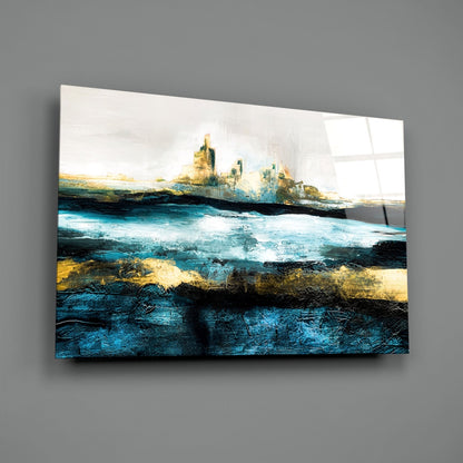 Abstract glass wall art depicting layered turquoise ocean waves with golden cliffs against white sky, displayed on gray wall.
