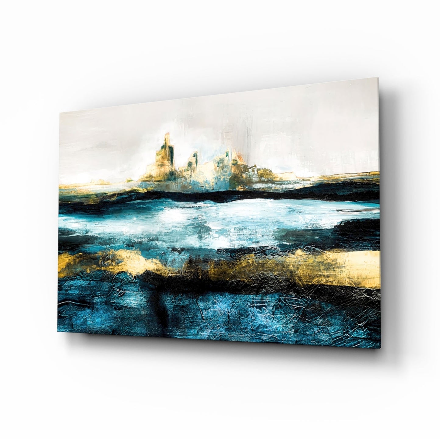 Abstract coastal landscape glass wall art featuring layered blue, gold, and black tones with distant rocky formations and turbulent waters.