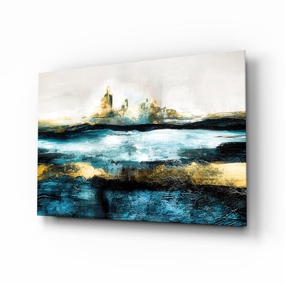 Abstract coastal landscape glass wall art featuring layered blue, gold, and black tones with distant rocky formations and turbulent waters.